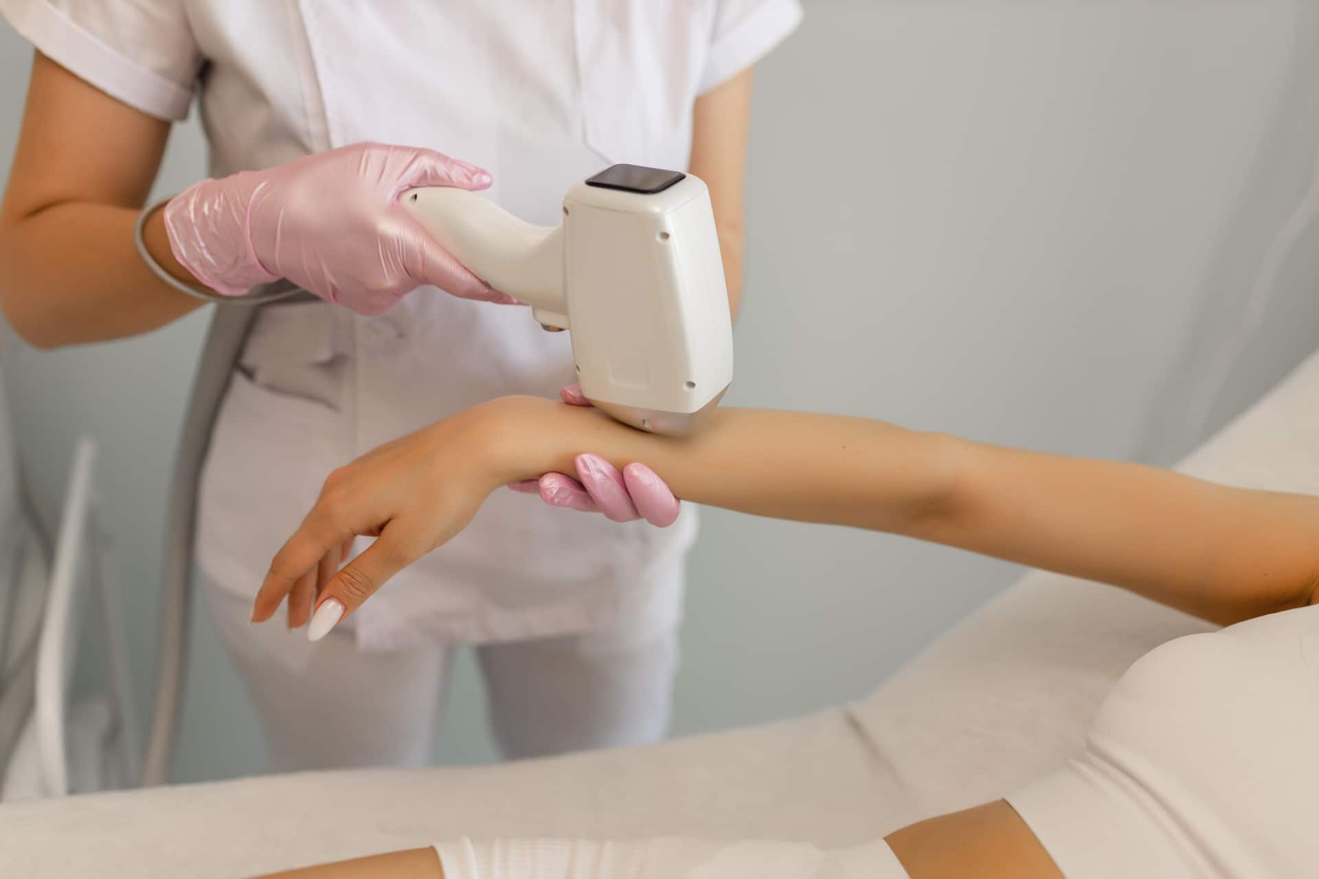 Hair removal procedure. Cropped shot of young fit woman client receiving laser hair removal procedure on body in beauty clinic. Women beauty and cosmetology concept